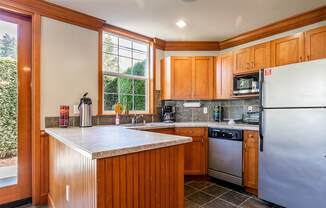 Kitchen with stainless steel appliances - Springbrook Apartments