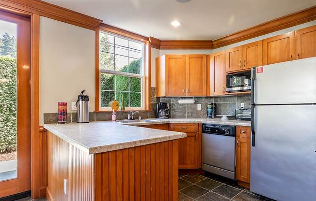 Kitchen with stainless steel appliances - Springbrook Apartments