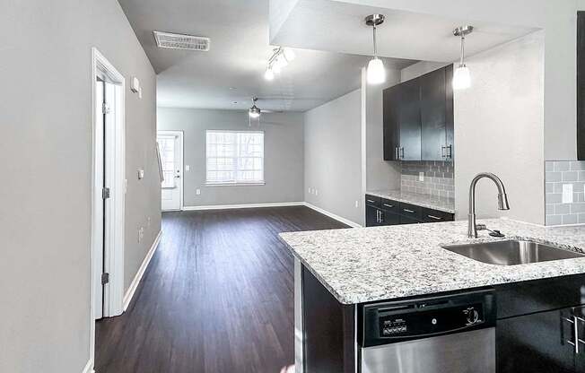 Open concept townhome with kitchen overlooking living and dining areas