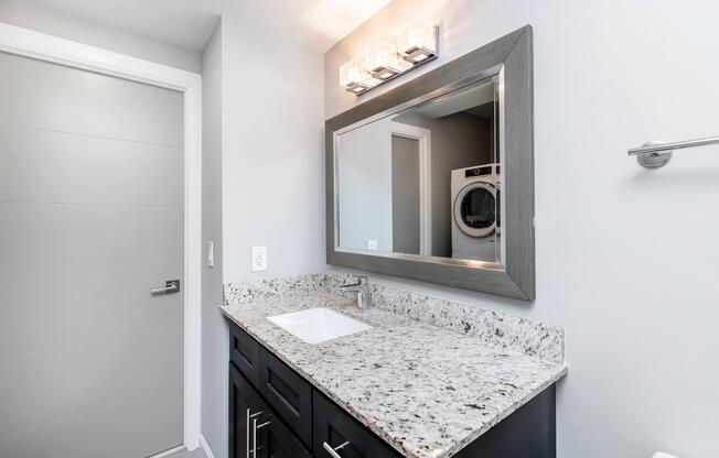 a room with a sink and a mirror