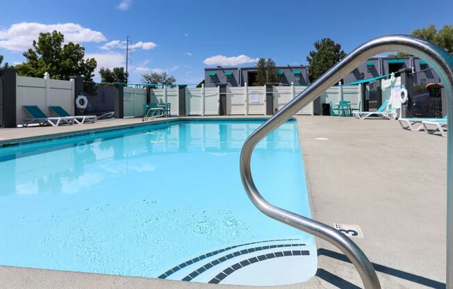 a swimming pool with a metal fence around it