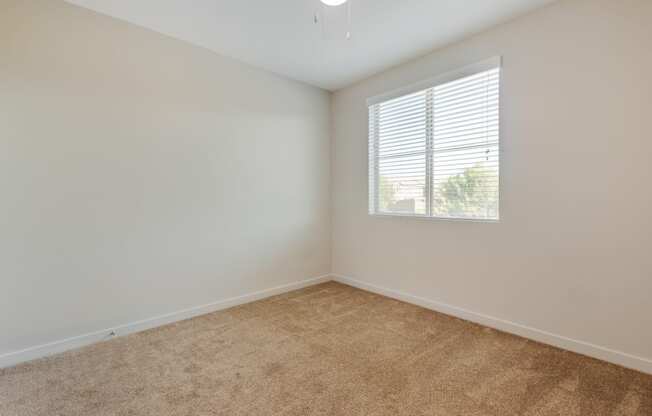 an empty room with carpet and a window at Metro Gateway, California