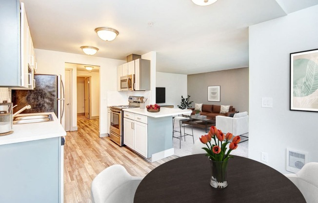 a living room and kitchen with a table and chairs