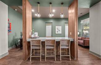 A dining room with a table and chairs.