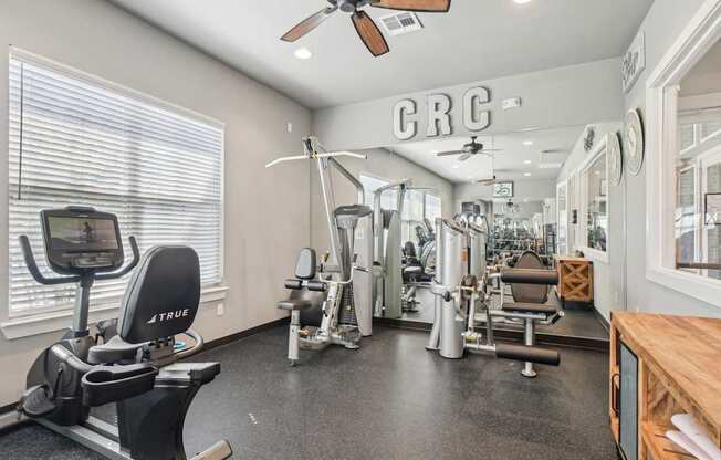 A gym with a TRUENE treadmill and a CRC logo on the wall.