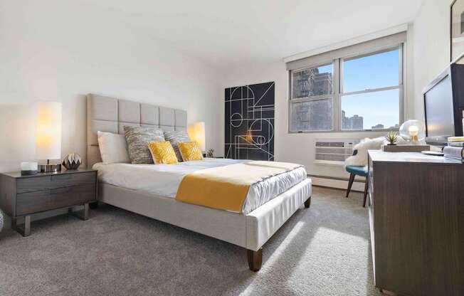 Large bedroom with plush carpeting and large windows