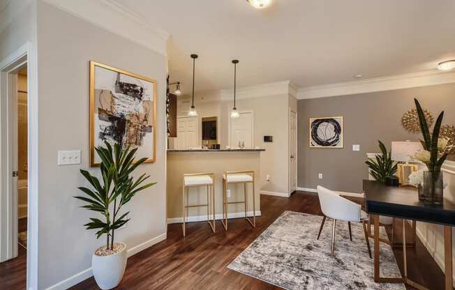 a living room and kitchen with a table and chairs