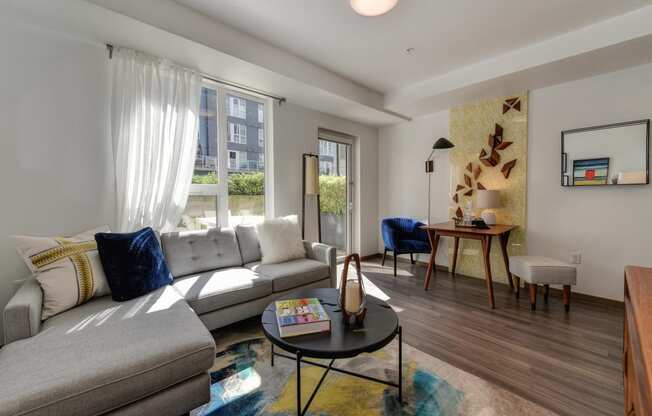 Living Room with Window, , Hardwood Inspired Floor, White Sofa and Colorful Rug