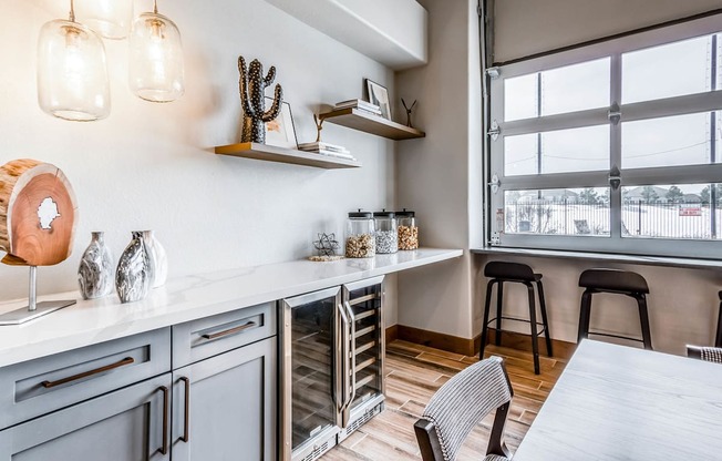 a kitchen with a large window and a table with chairs at The links at Plum Creek Apartments, Castlerock