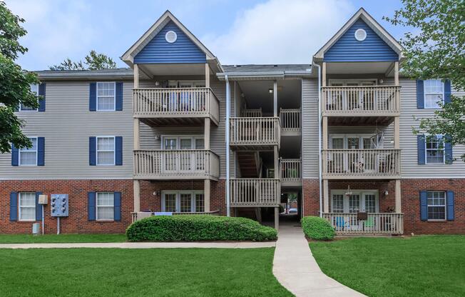 Apartment building exterior and lawn at Ashley Oaks Apartments in Greensboro, North Carolina