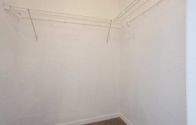 A white wall with a metal rack on it.
