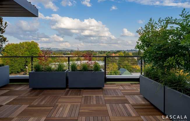 Rooftop patio with a view of Portland at LaScala Apartments in Beaverton, Oregon