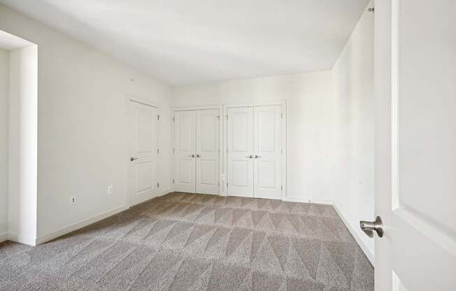 A room with a carpeted floor and white walls.