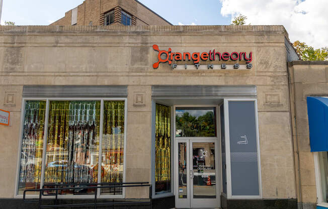 the front of a store with a sign on the side of a building