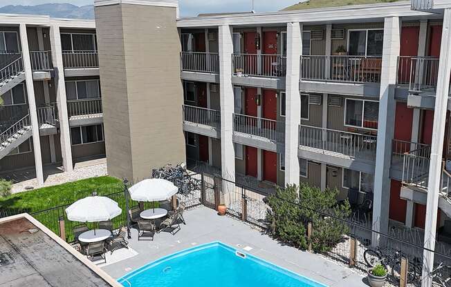 A pool in front of apartment buildings.