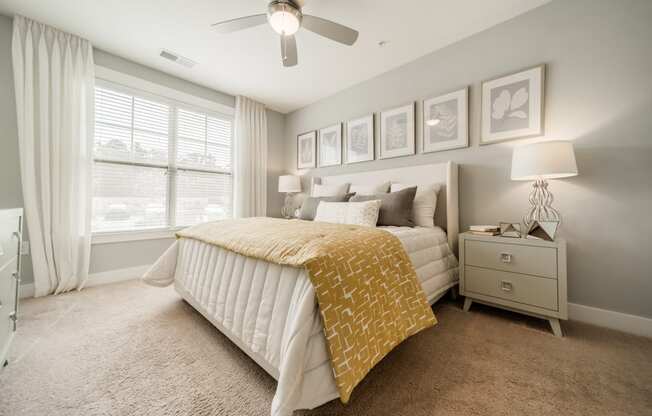 a bedroom with a bed and a ceiling fan