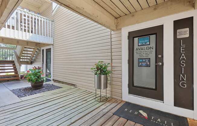 a front porch with a welcome rug in front of a door at The Avalon Apartment Homes, Missouri, 63017