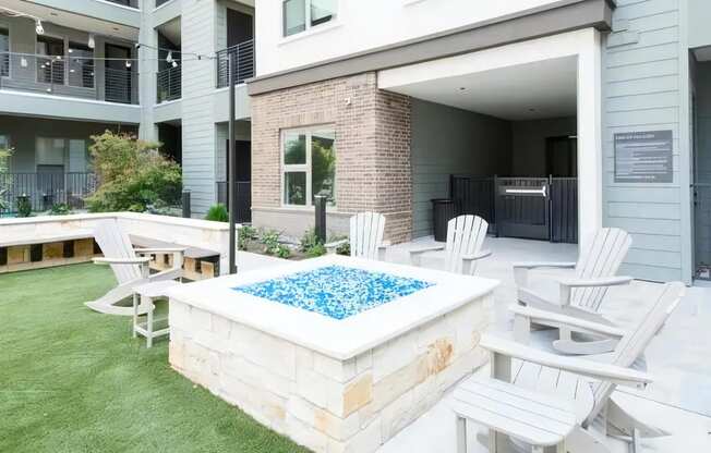 an outdoor patio with a pool and chairs around it