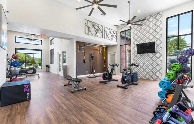 a home gym with weights and a tv on the wall