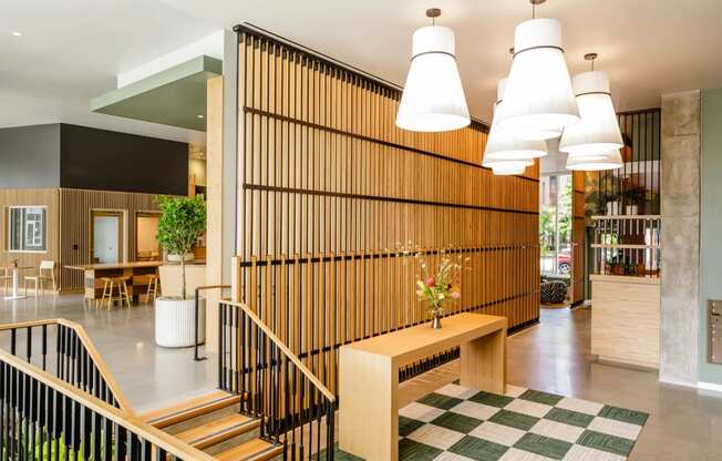 the lobby with a wooden wall and a staircase at Slabtown Square Apartments, Oregon, 97209