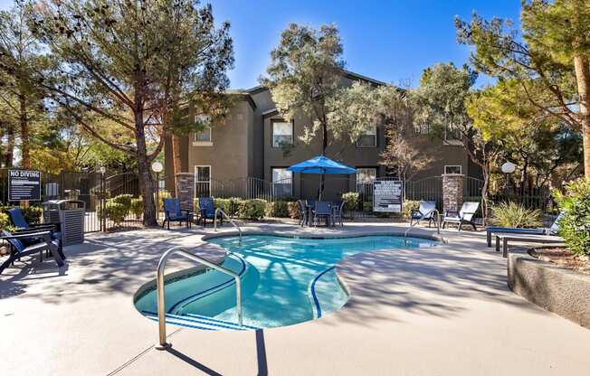 A pool surrounded by trees and chairs with a sign that says "NO RVING".