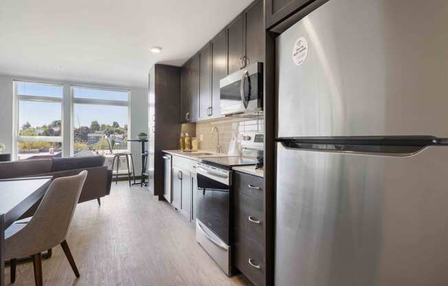 kitchens equipped with stainless steel appliances and dark cabinets