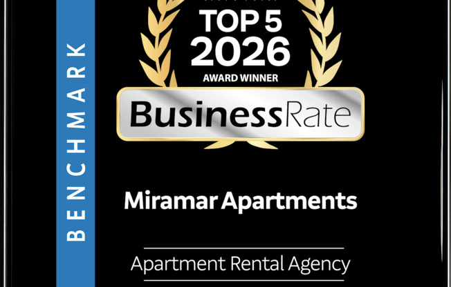 A black and gold award sign for Miramar Apartments.