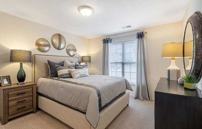 a bedroom with a large bed and a window