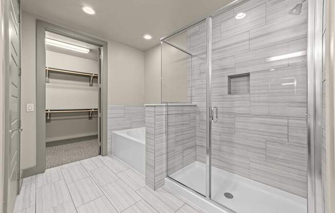 A modern bathroom with a walk-in shower and a towel bar.