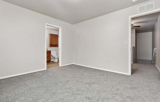 A room with a carpeted floor and white walls.