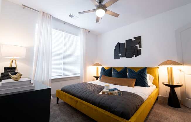 a bedroom with a large bed and a ceiling fan