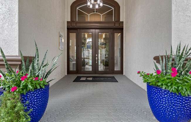 a view of the entrance to a building with flowers in the lobby