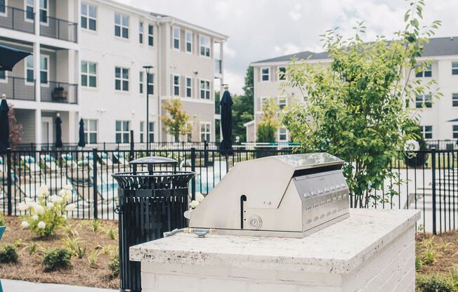 a small brick smoker in front of an apartment building