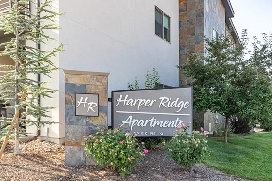 a building with a sign that says harper ridge apartments