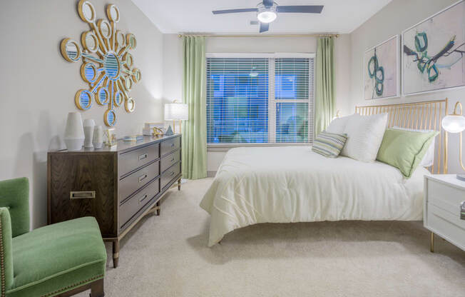 a bedroom with a bed and a dresser and a window