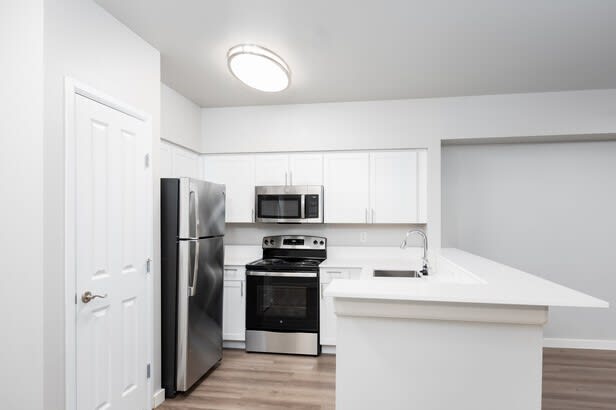 a kitchen with a refrigerator stove and microwave