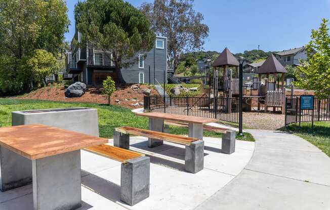 A park with a playground and benches.