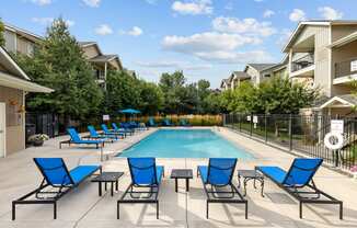 our apartments have a swimming pool with blue chairs