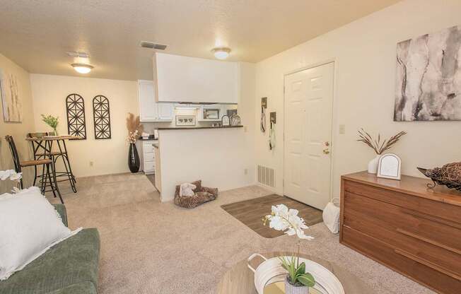 A living room with a green couch and a white wall at Zinfandel Village Apartments, California, 95670