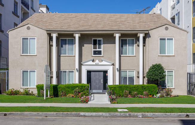 a large house with a sidewalk in front of it