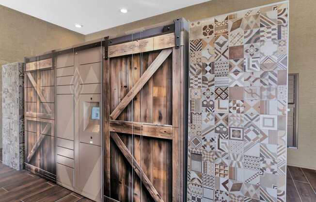 A large wooden door with a decorative tile wall on the side.