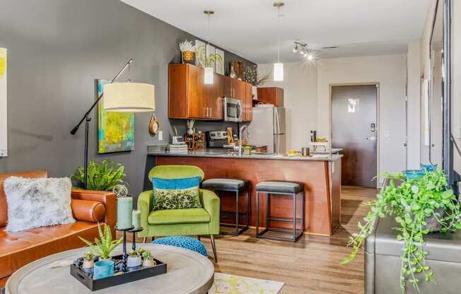 a living room with a kitchen in the background