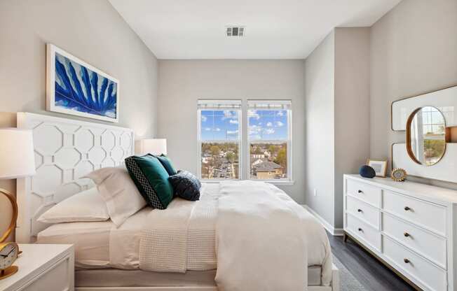 a bedroom with a large bed and a large window at Metro 303, Hempstead, NY 11550
