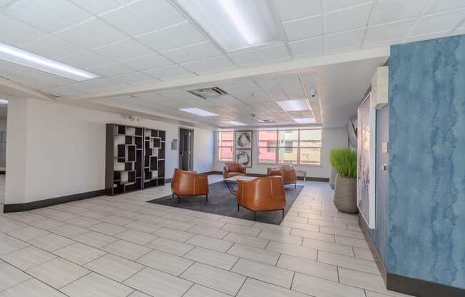an empty waiting room in a hospital with leather chairs