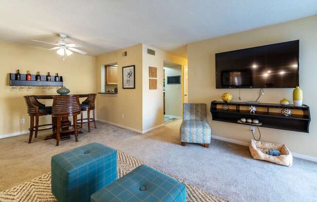 a living room with a tv and a dining room table