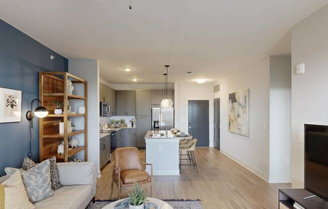 a living room and kitchen with a couch and a table