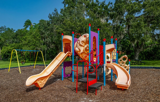 a playground with a slide and other playground equipment