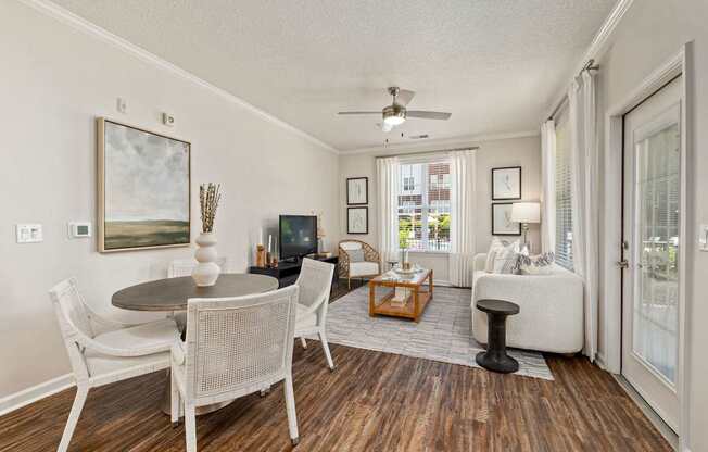 A living room with a dining table and chairs.