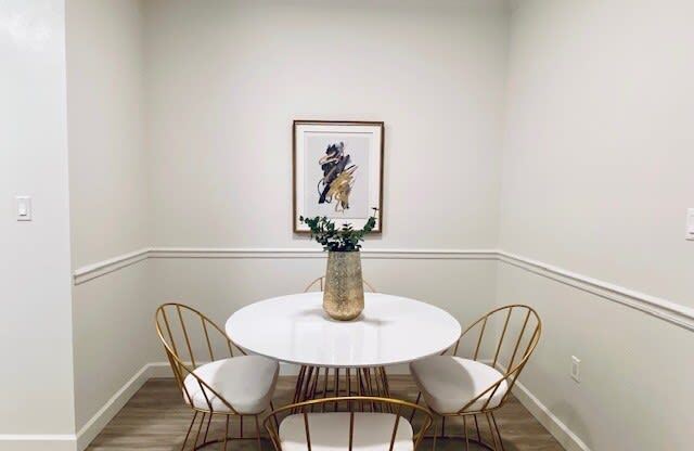 dining room with a white table and chairs at Mainstreet Apartments, Clearwater