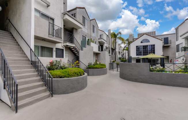 Community grounds and walk path throughout the community.  There are staircases that lead up to the 2nd floor homes and the swimming pool area is in the distance.  